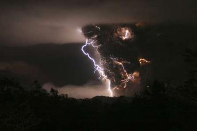 Lightning bolts appear above and around the Chaiten volcano ...